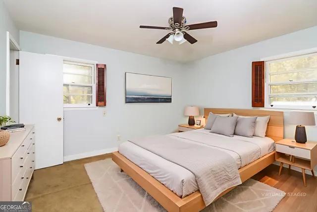 a bedroom with a large bed and a window