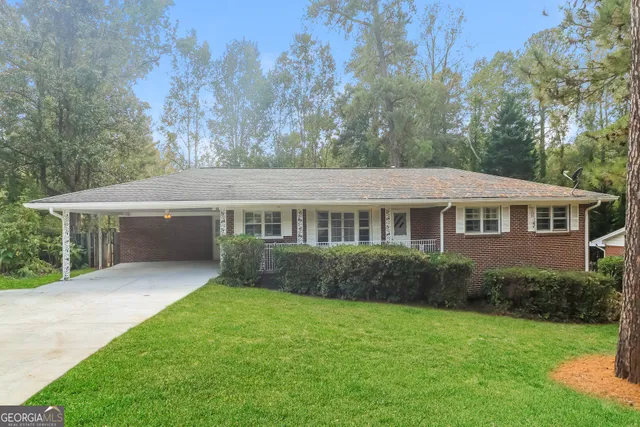 a aerial view of a house next to a big yard and large trees