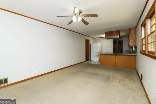 a view of a kitchen with furniture and a ceiling fan