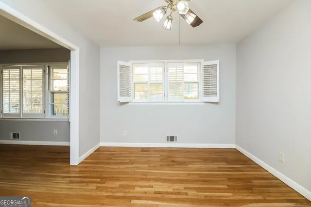 a view of a room with wooden floor and chandelier