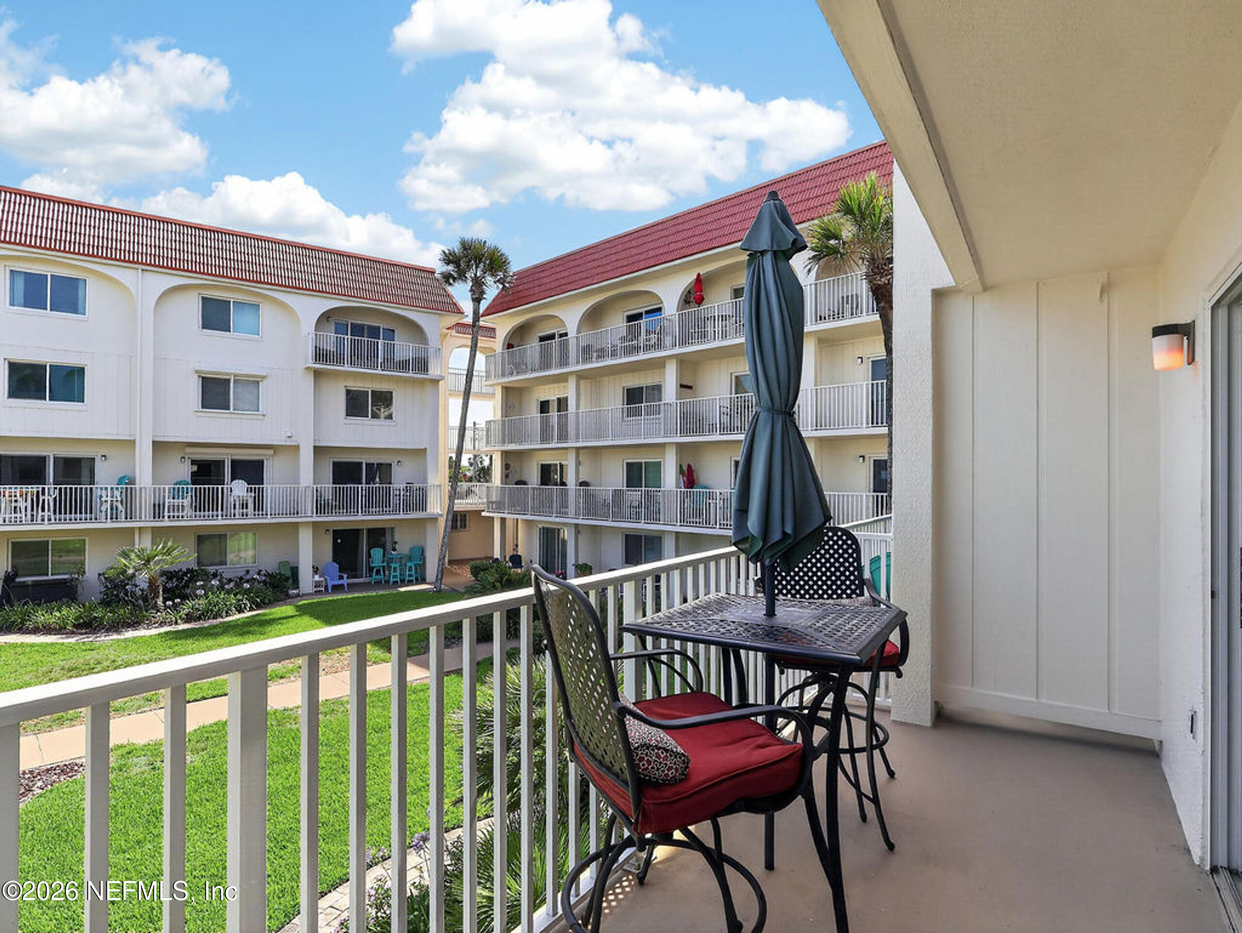 1 Ocean Trace Road, Unit 230 St. Augustine Beach, FL 32080 - Photo 14 of 50 a roof deck with table and chairs