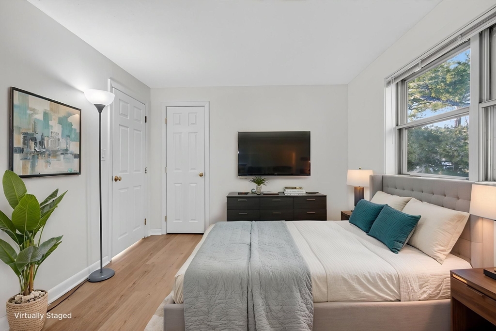 A1 Colonial Drive, Unit 10 Andover, MA 01810 - Photo 6 of 18 a bedroom with a bed and a flat screen tv
