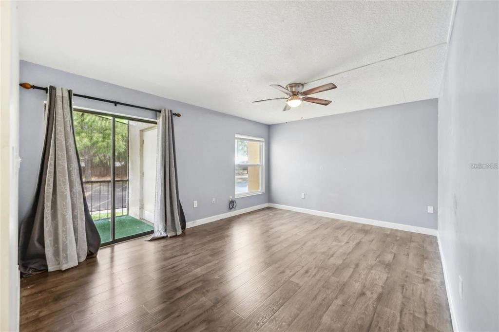 610 Cranes Way, Unit 207 Altamonte Springs, FL 32701 - Photo 12 of 27 wooden floor in an empty room with a window