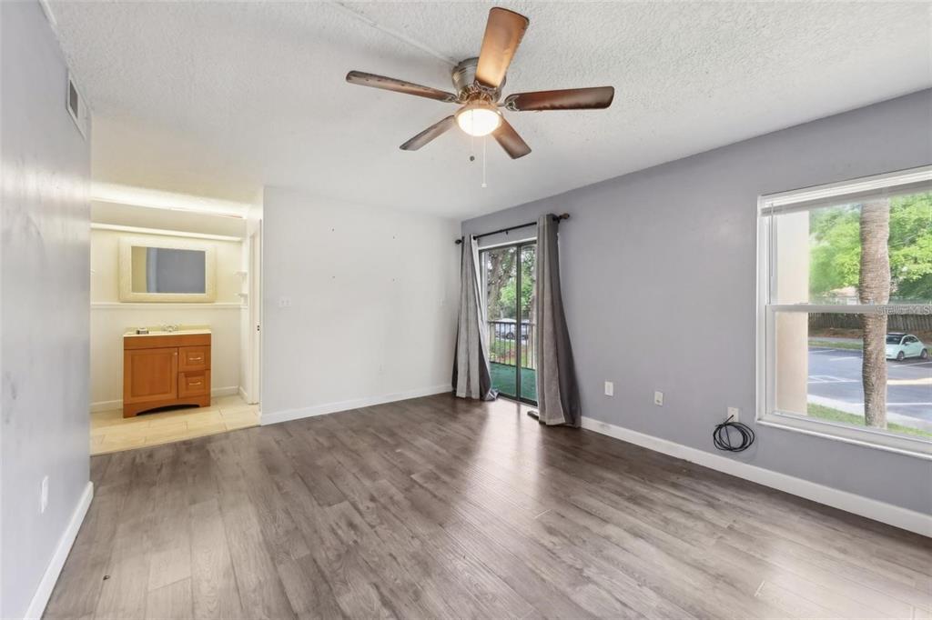 610 Cranes Way, Unit 207 Altamonte Springs, FL 32701 - Photo 15 of 27 a view of an empty room with a window and wooden floor