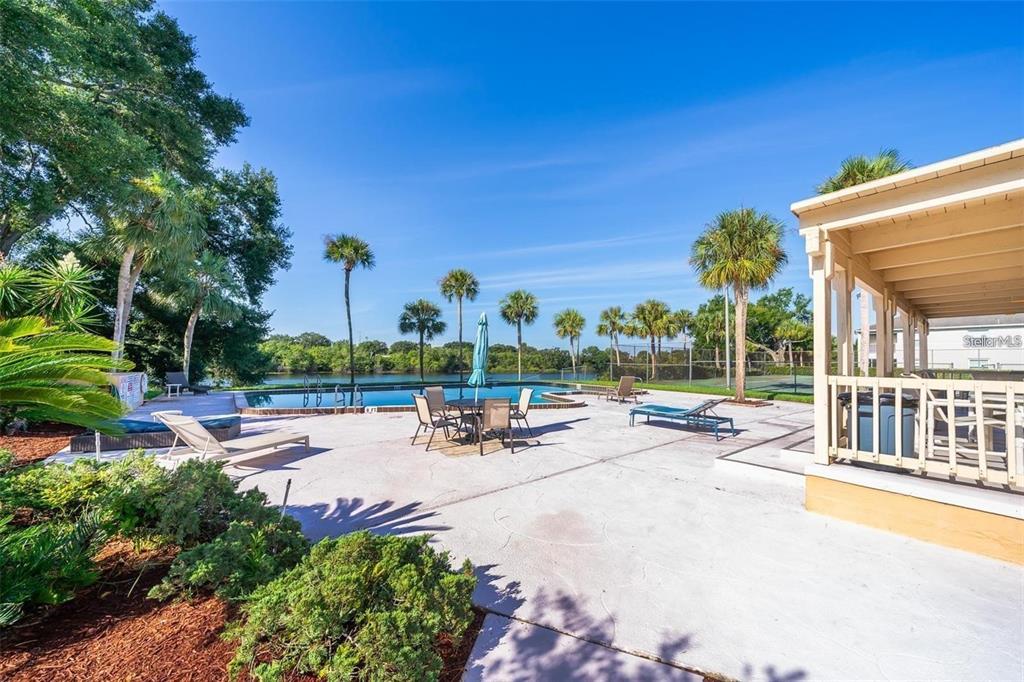 610 Cranes Way, Unit 207 Altamonte Springs, FL 32701 - Photo 24 of 27 a view of a patio with a table and chairs under an umbrella