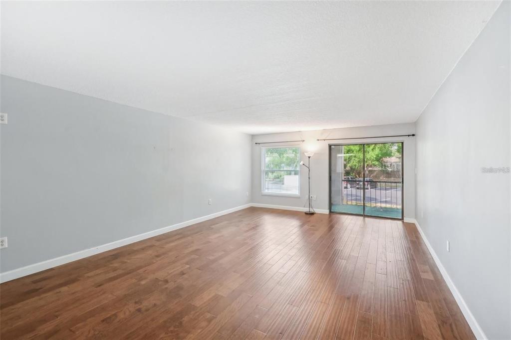 610 Cranes Way, Unit 207 Altamonte Springs, FL 32701 - Photo 3 of 27 wooden floor in an empty room with a window