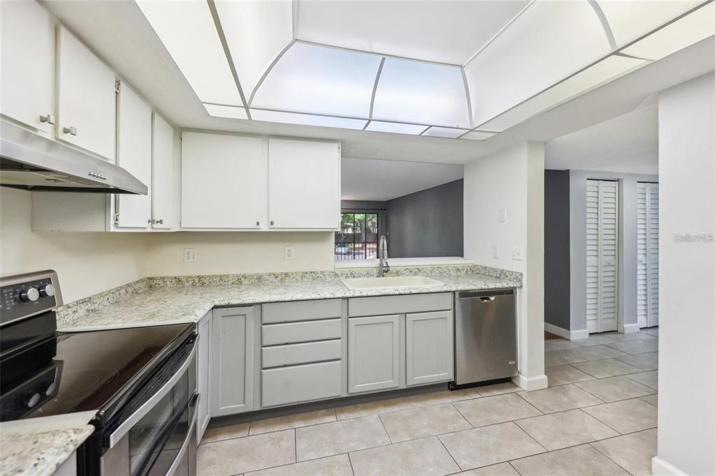 610 Cranes Way, Unit 207 Altamonte Springs, FL 32701 - Photo 5 of 27 a kitchen with a sink stove and cabinets