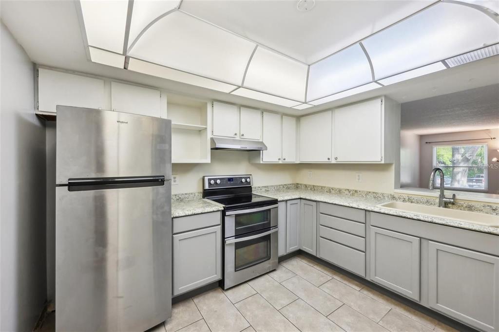 610 Cranes Way, Unit 207 Altamonte Springs, FL 32701 - Photo 6 of 27 a kitchen with stainless steel appliances a refrigerator sink and cabinets