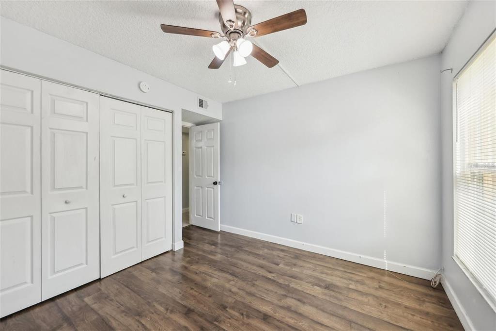 610 Cranes Way, Unit 207 Altamonte Springs, FL 32701 - Photo 9 of 27 an empty room with wooden floor fan and windows