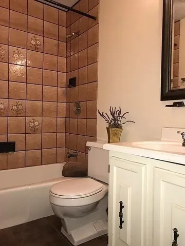 a bathroom with a toilet a sink and bathtub