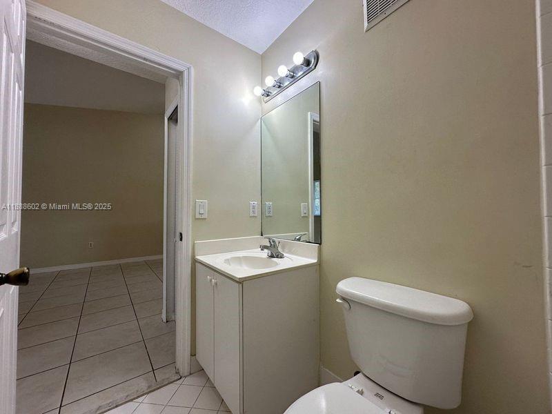 1260 Southeast 29th Street, Unit 20359 Homestead, FL 33035 - Photo 12 of 19 a bathroom with a toilet sink and mirror