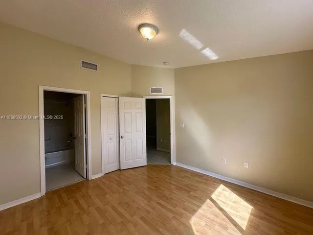 a view of an empty room and wooden floor