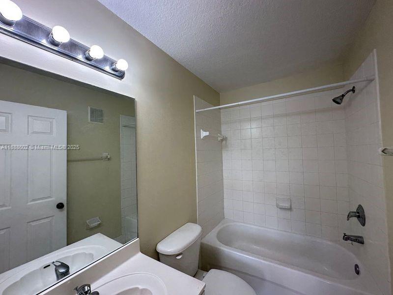 1260 Southeast 29th Street, Unit 20359 Homestead, FL 33035 - Photo 15 of 19 a bathroom with a granite countertop sink a toilet and shower