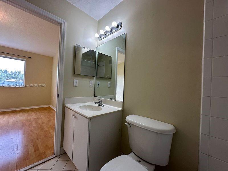 1260 Southeast 29th Street, Unit 20359 Homestead, FL 33035 - Photo 17 of 19 a bathroom with a toilet sink and mirror