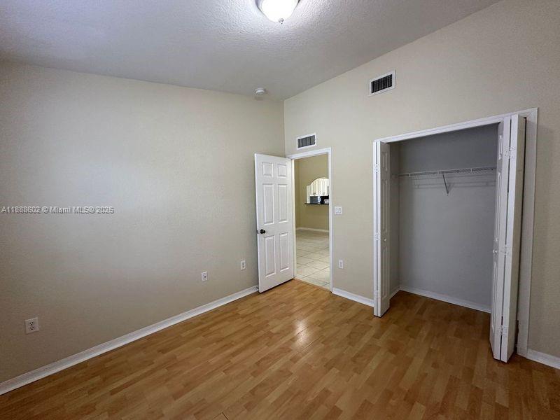 1260 Southeast 29th Street, Unit 20359 Homestead, FL 33035 - Photo 9 of 19 an empty room with wooden floor and bathroom