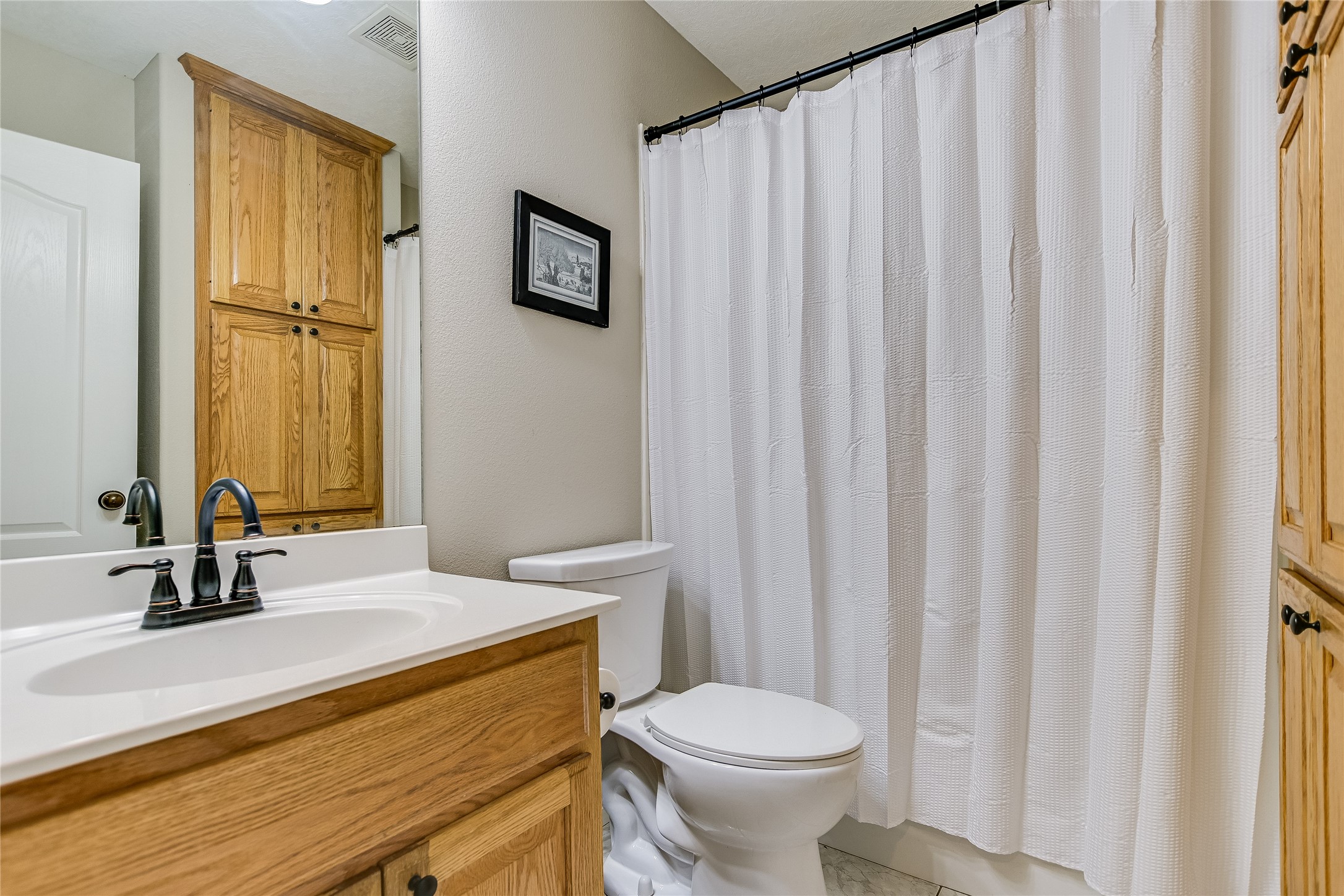 741 Knobbs Road McDade, TX 78650 - Photo 21 of 38 A well-appointed bathroom features a practical vanity and convenient shower area.