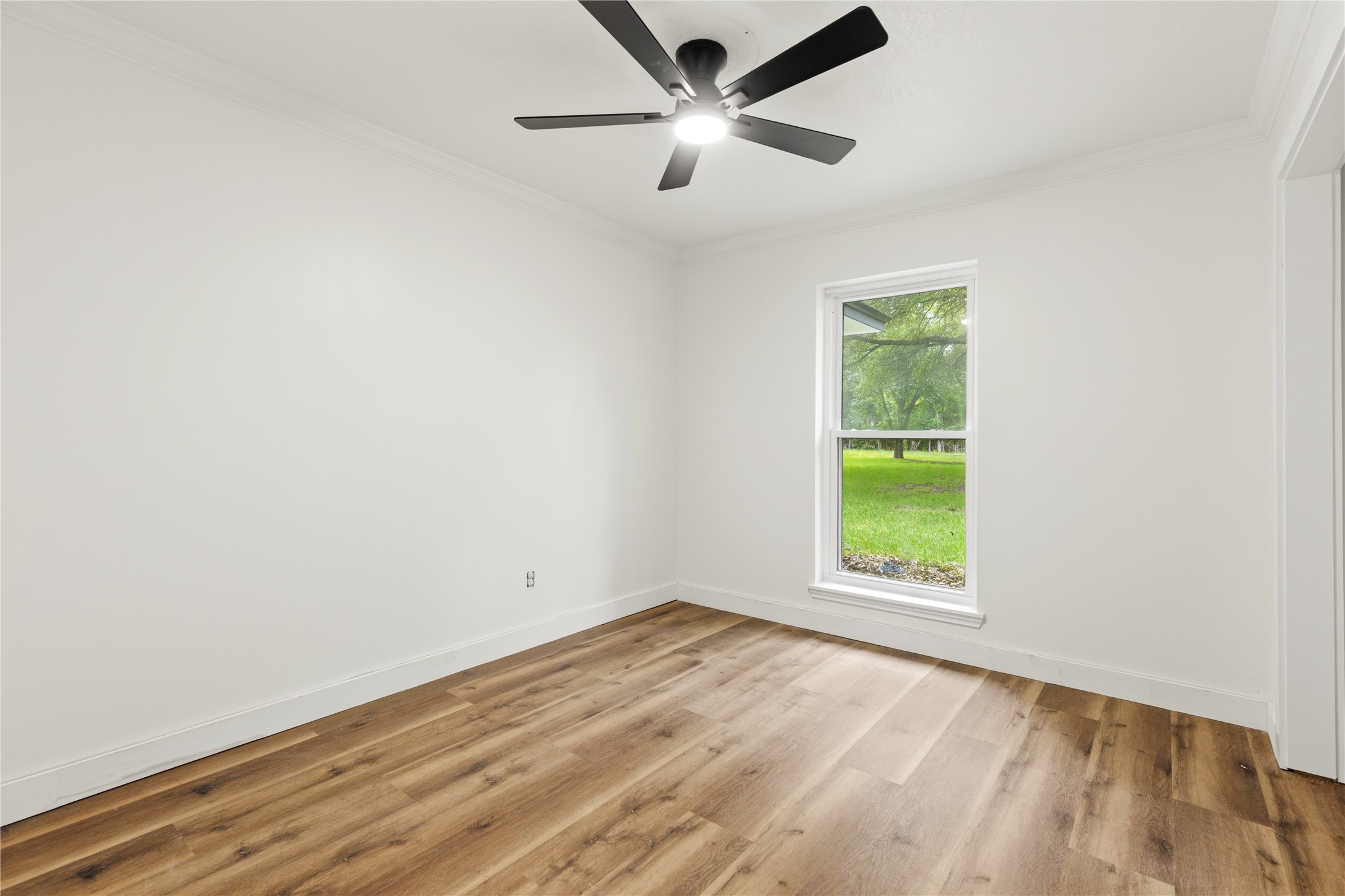 74 Robinson Road Huntsville, TX 77320 - Photo 20 of 33 an empty room with a window and a fan