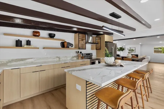 a kitchen with a sink a stove and cabinets