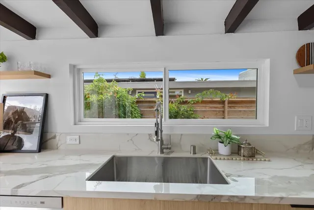 a kitchen with a sink and large window