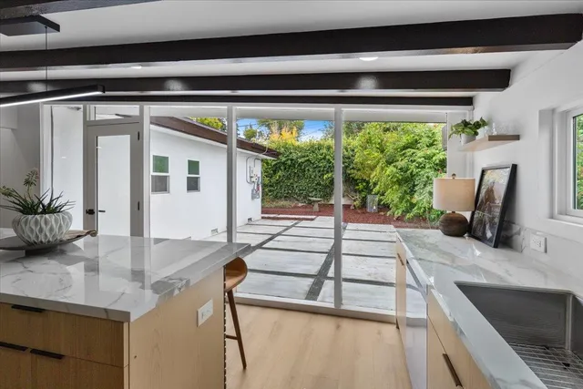 a kitchen with a sink and a large window