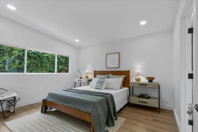 a bedroom with a bed and a window