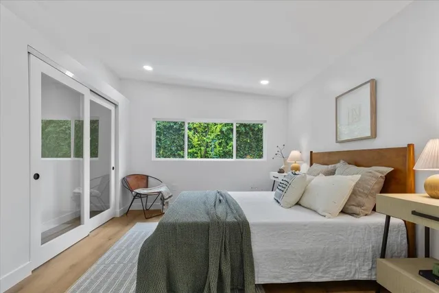 a bedroom with a bed and wooden floor
