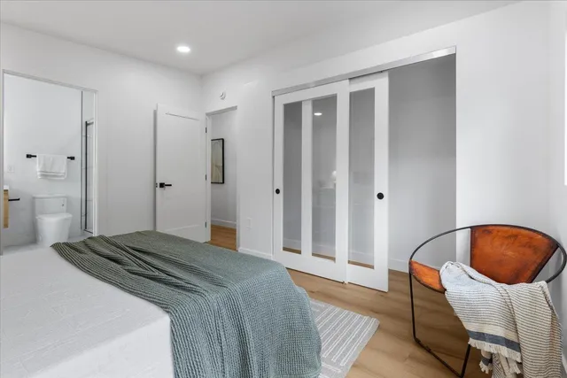 a bedroom with a bed and a chair