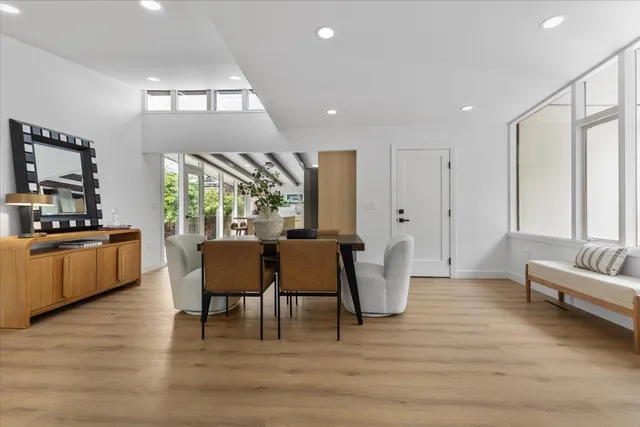 a dining room with furniture and wooden floor
