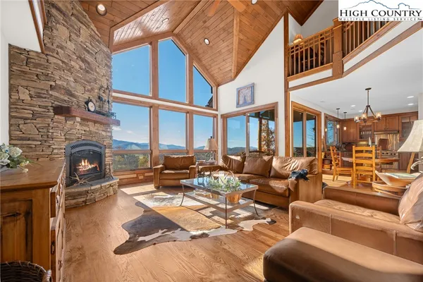 a view of a patio with couches table and chairs and potted plants