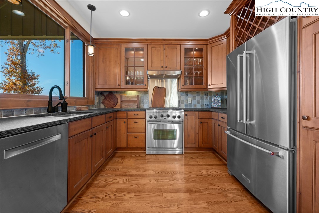 138 Springhouse Drive, Unit C2 Elk Park, NC 28622 - Photo 11 of 44 a kitchen with stainless steel appliances granite countertop a refrigerator a stove and a sink