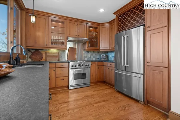 a kitchen with stainless steel appliances granite countertop a refrigerator sink and stove