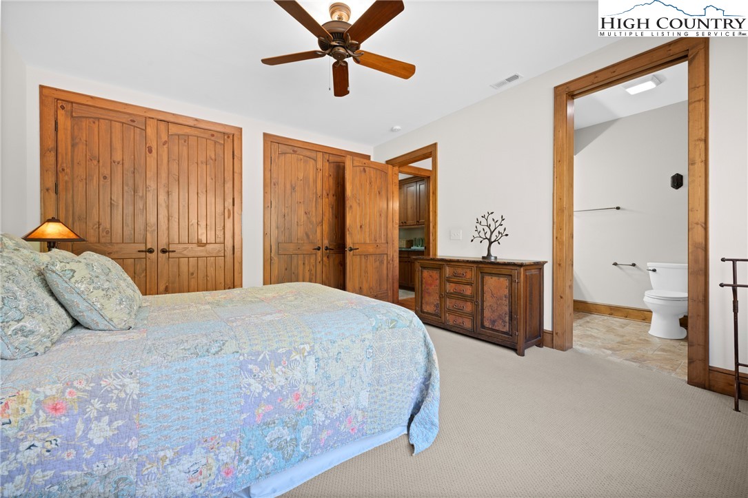 138 Springhouse Drive, Unit C2 Elk Park, NC 28622 - Photo 18 of 44 a bedroom with a bed and a chandelier