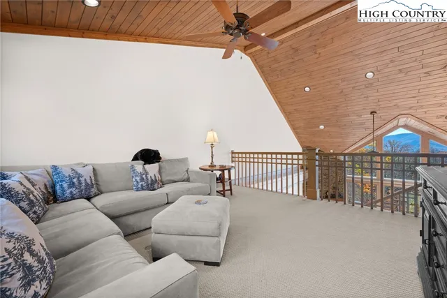 a living room with a bed and a desk