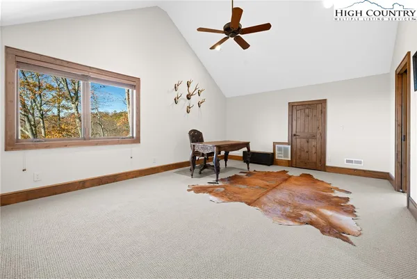 a view of a livingroom with furniture and a window