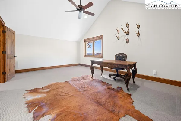 a living room with a bed and a desk