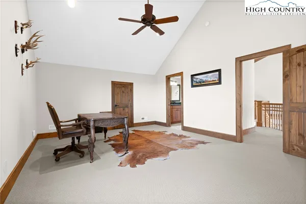a view of a workspace with furniture and a window