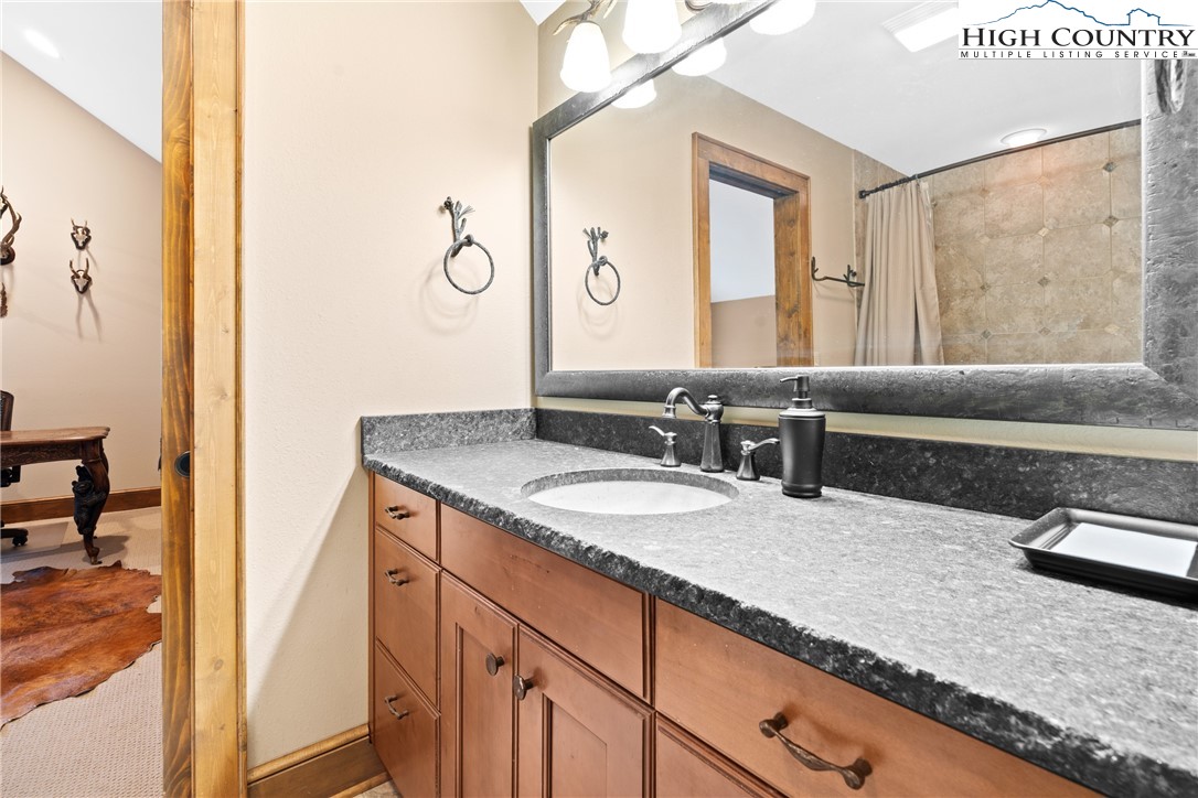 138 Springhouse Drive, Unit C2 Elk Park, NC 28622 - Photo 30 of 44 a en suite bathroom with a granite countertop double vanity sink and a mirror