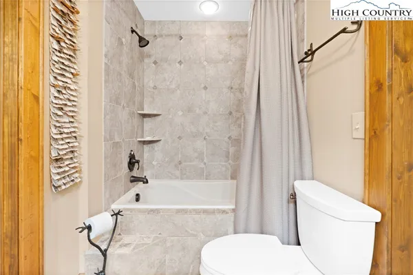 a bathroom with a toilet and a bathtub