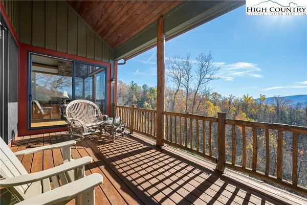 a balcony view with a large window and seating space