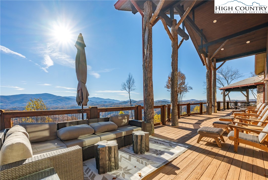138 Springhouse Drive, Unit C2 Elk Park, NC 28622 - Photo 40 of 44 a living room with furniture a rug and a floor to ceiling window