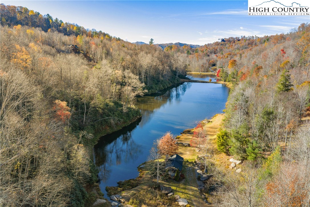138 Springhouse Drive, Unit C2 Elk Park, NC 28622 - Photo 42 of 44 a view of a lake with mountains in the background