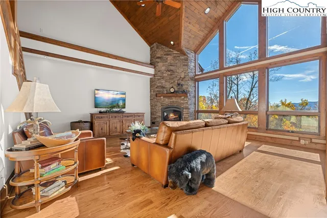 a living room with fireplace furniture and a wooden floor