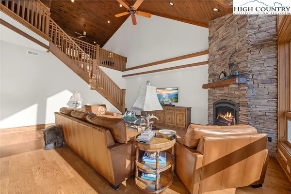 a living room with fireplace furniture and a wooden floor