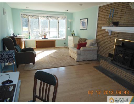 25 Penn Lyle Road West Windsor, NJ 08550 - Photo 11 of 25 a living room with furniture and a fireplace