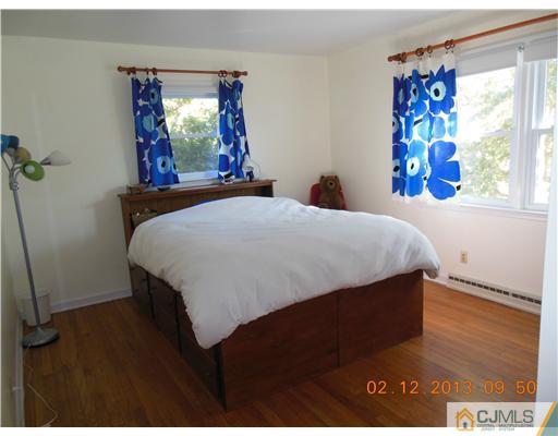 25 Penn Lyle Road West Windsor, NJ 08550 - Photo 17 of 25 a bed sitting in a bedroom next to a window