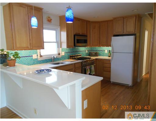25 Penn Lyle Road West Windsor, NJ 08550 - Photo 8 of 25 a kitchen with a refrigerator a stove a microwave a sink and cabinets