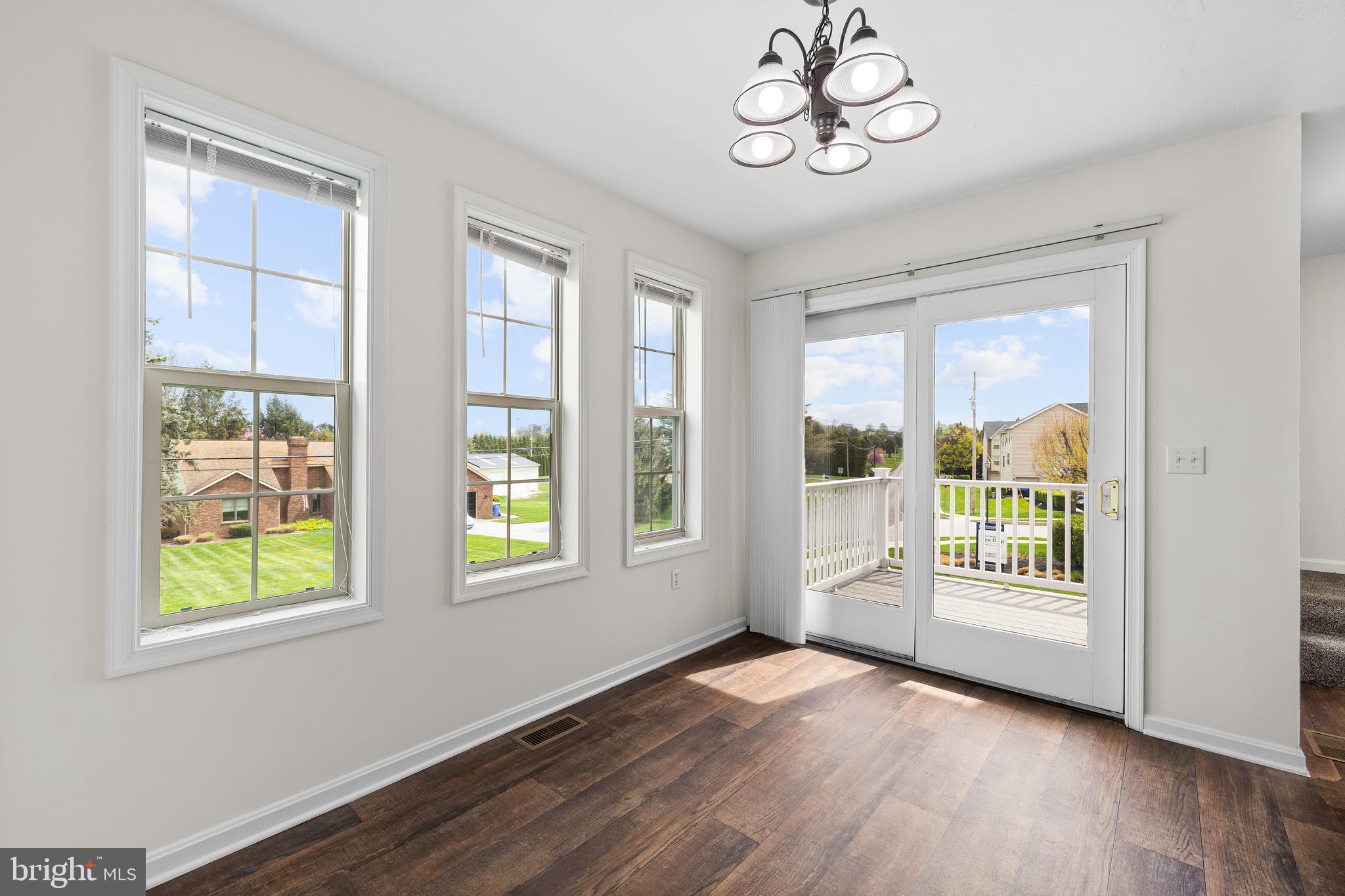 22 Shady Tree Court York, PA 17402 - Photo 11 of 23 a view of an empty room with a window and wooden floor