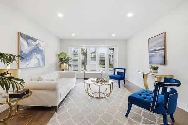 a living room with furniture a flat screen tv and a potted plant