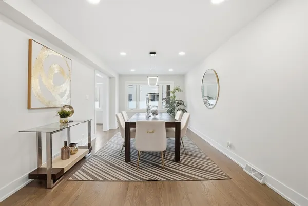 a dining room with furniture a rug and wooden floor