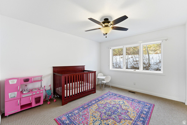 1878 East Ridge Point Drive Bountiful, UT 84010 - Photo 36 of 92 Bedroom featuring light colored carpet, a nursery area, and a ceiling fan